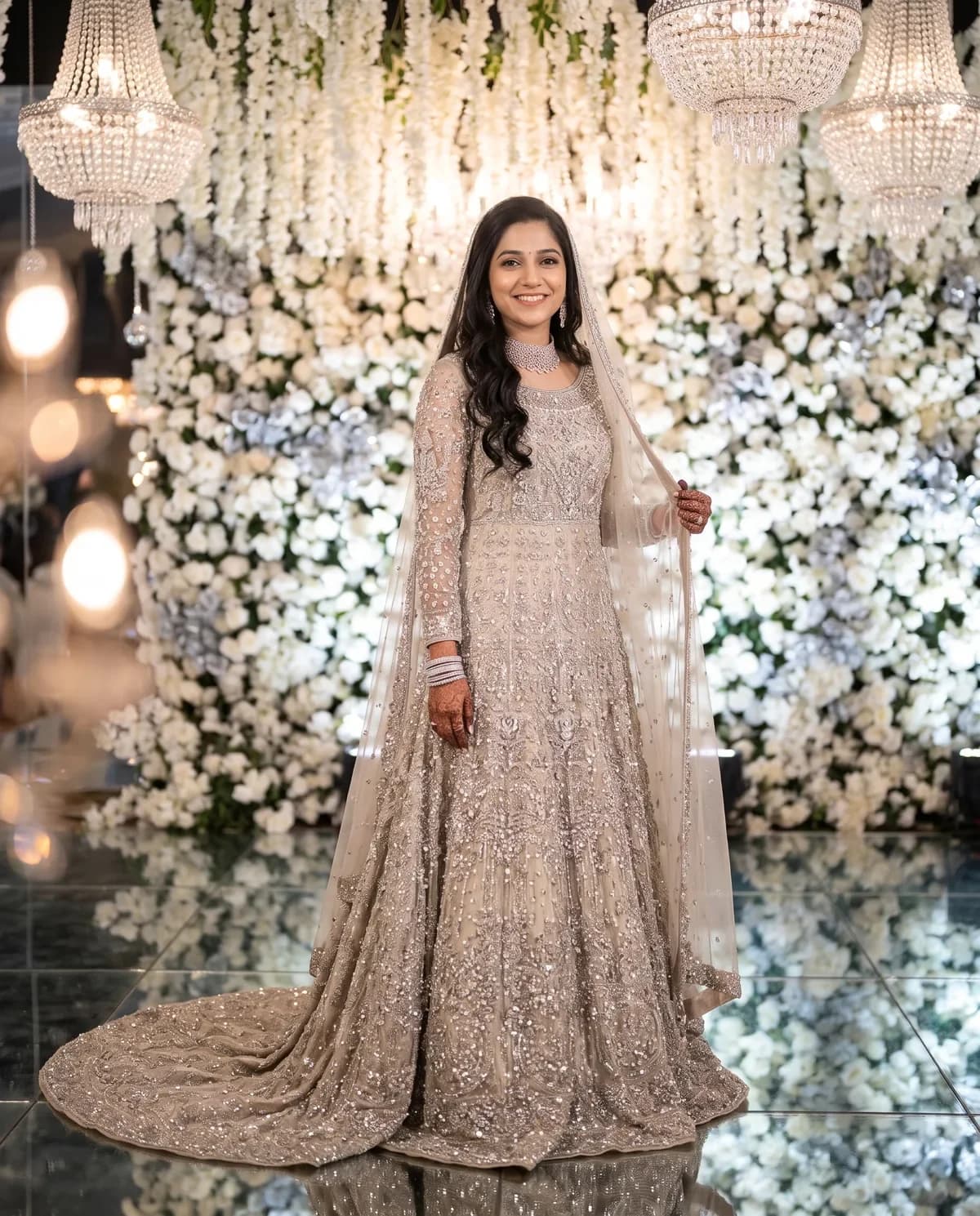 Bride in a silver champagne embellished walima maxi after a dulhan photo AI prompt.