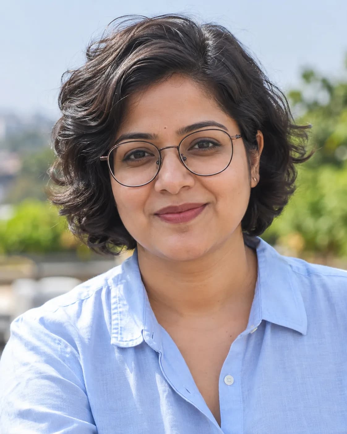 AI-generated portrait of a woman with glasses in a blue shirt.